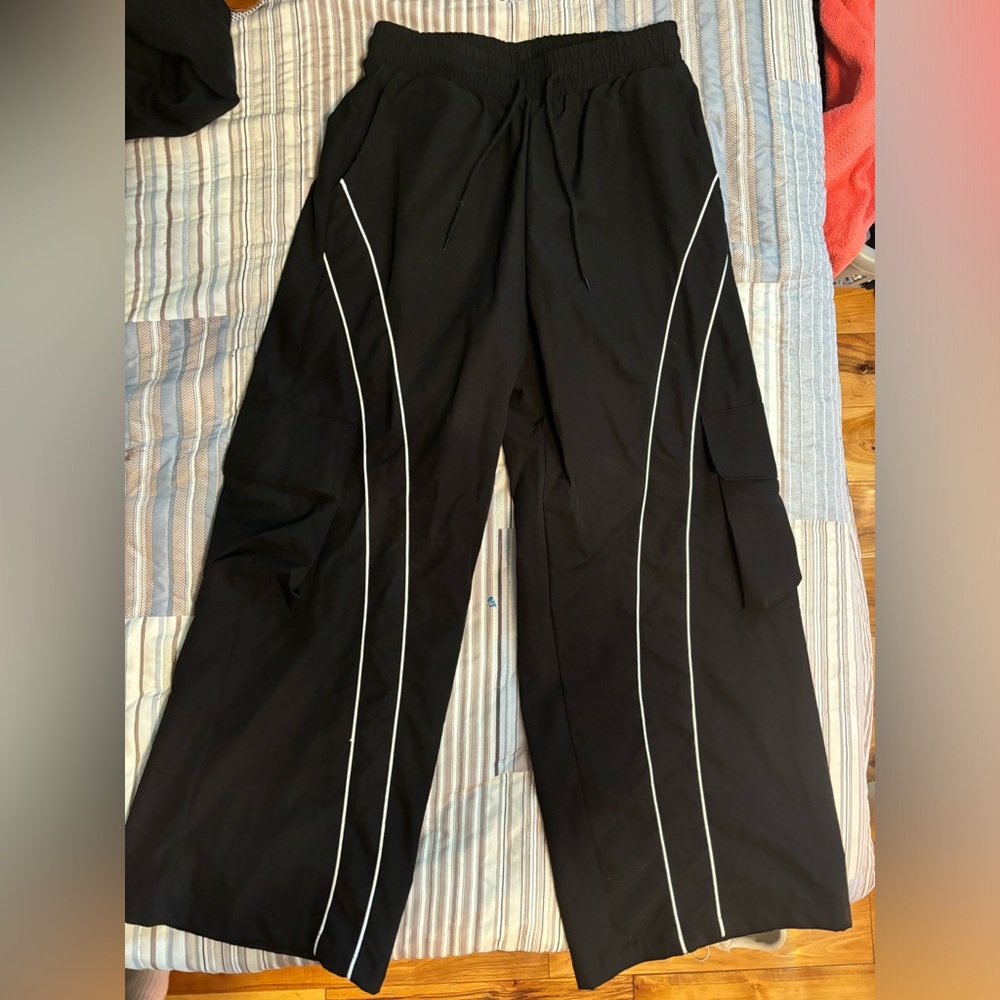 Black wide leg pants with flap pockets and elastic waistband